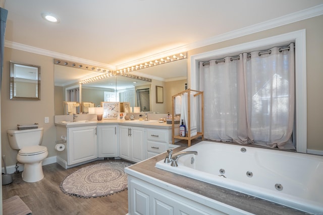 bathroom featuring crown molding, a tub to relax in, hardwood / wood-style flooring, toilet, and vanity