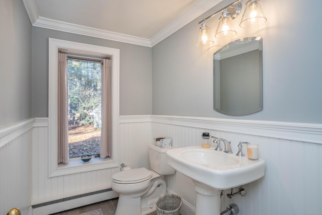 bathroom with crown molding, hardwood / wood-style flooring, toilet, and a baseboard heating unit