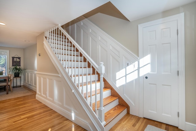 stairway with hardwood / wood-style floors