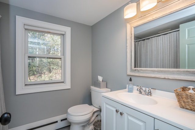 bathroom featuring a baseboard heating unit, vanity, and toilet