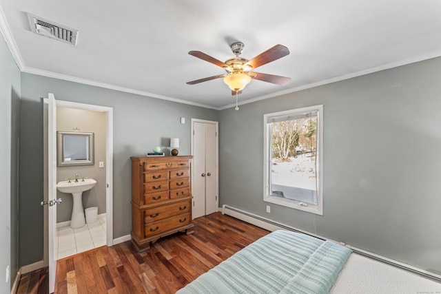 bedroom with dark hardwood / wood-style flooring, crown molding, ensuite bath, and ceiling fan