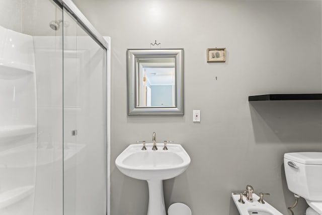 bathroom with a bidet, toilet, and an enclosed shower