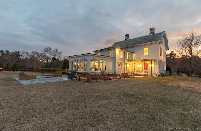 114 Walkley Hill Rd, Haddam, CT 06438 - back of property featuring a patio area, a chimney, a yard, and a sunroom