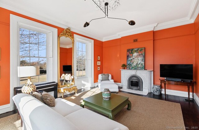 114 Walkley Hill Rd, Haddam, CT 06438 - living area with crown molding, wood finished floors, and a fireplace with raised hearth