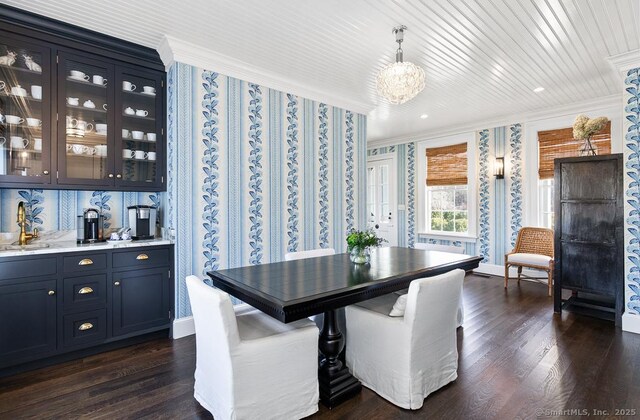 114 Walkley Hill Rd, Haddam, CT 06438 - dining room with crown molding, a chandelier, dark wood finished floors, and bar with sink