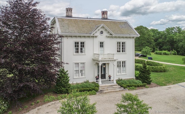 114 Walkley Hill Rd, Haddam, CT 06438 - view of front of property with a chimney, a front lawn, a balcony, and stucco siding