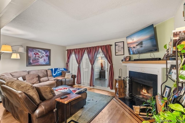 living room with a textured ceiling and light hardwood / wood-style floors