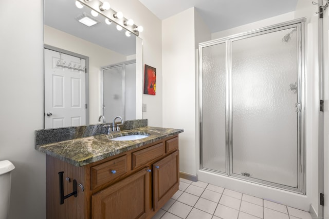 bathroom featuring vanity, a shower with door, and tile patterned flooring