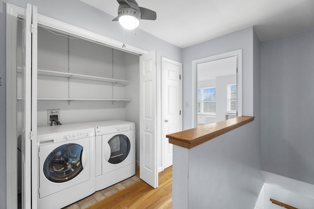 laundry area featuring separate washer and dryer, light wood-type flooring, and ceiling fan