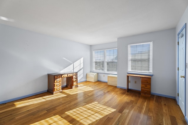 unfurnished living room with hardwood / wood-style flooring