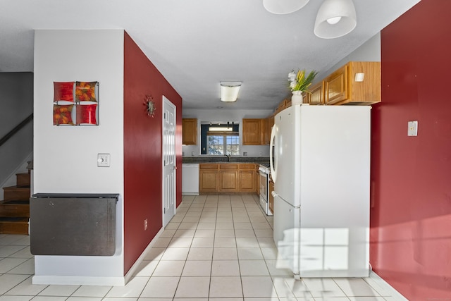 kitchen featuring white appliances and light tile patterned floors