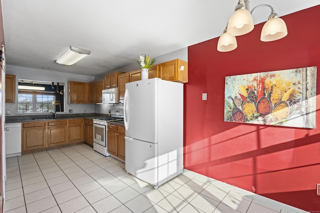 kitchen featuring pendant lighting and white appliances