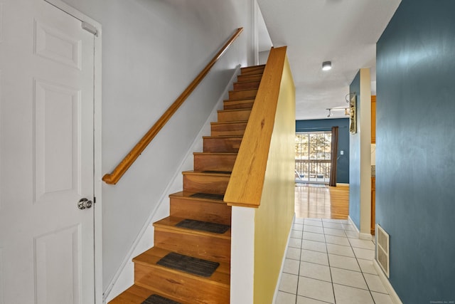 stairway featuring tile patterned flooring