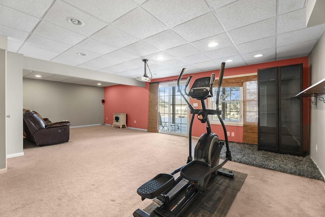 exercise room with carpet and a drop ceiling