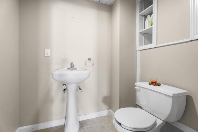 bathroom with toilet and tile patterned floors