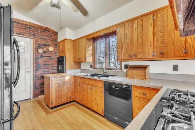 493 Babbs Rd, Suffield, CT 06093 - kitchen with black appliances, brick wall, light countertops, a ceiling fan, and light wood finished floors