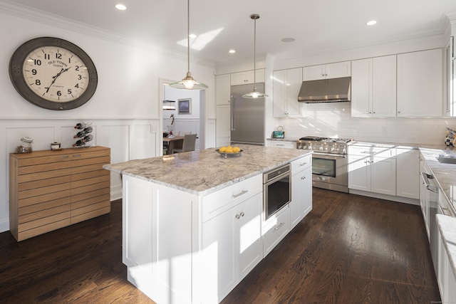 kitchen with high quality appliances, white cabinetry, hanging light fixtures, a center island, and light stone countertops