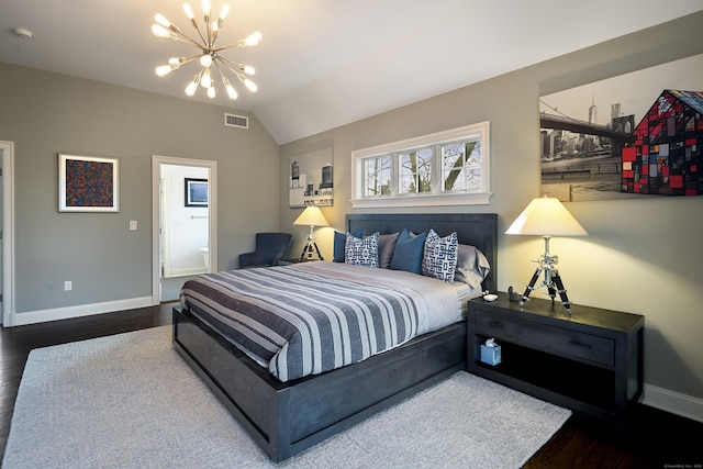 bedroom with lofted ceiling, hardwood / wood-style floors, and an inviting chandelier