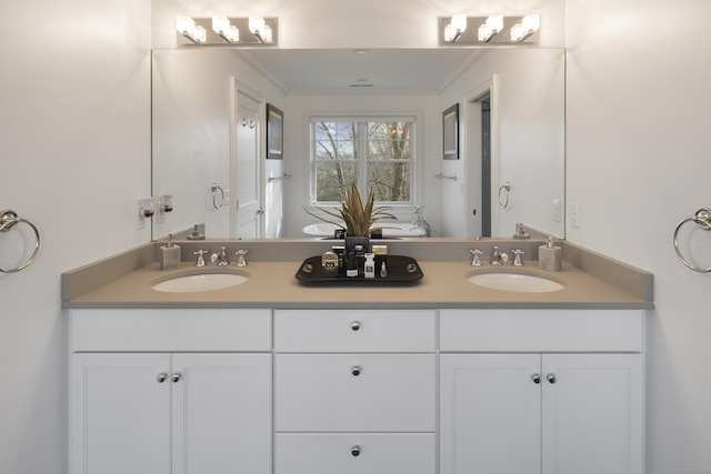 bathroom with vanity and ornamental molding