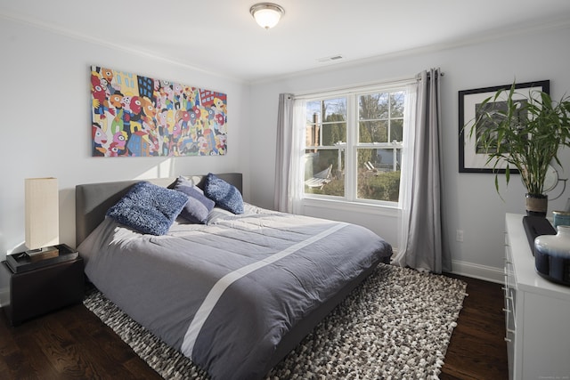 bedroom with ornamental molding and dark wood-type flooring