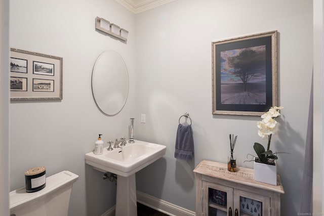 bathroom with crown molding and toilet