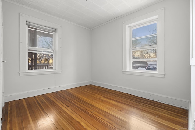 spare room with hardwood / wood-style flooring