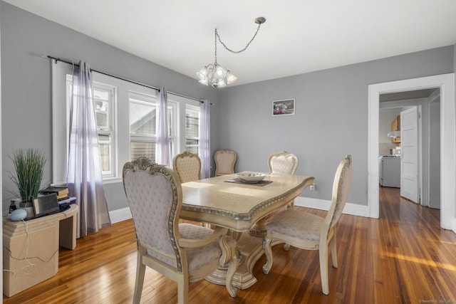 dining room featuring hardwood / wood-style floors and a notable chandelier