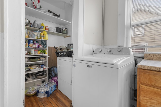 laundry room with hardwood / wood-style floors and independent washer and dryer