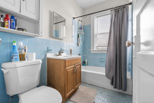 full bathroom featuring toilet, vanity, shower / bathtub combination with curtain, and tile walls