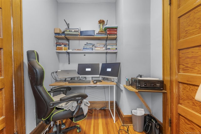 home office with wood-type flooring