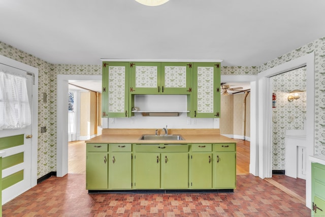 kitchen featuring sink, green cabinets, and ceiling fan