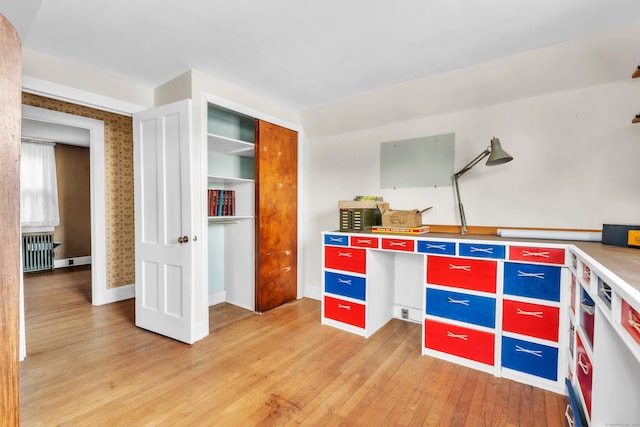 kitchen featuring radiator and hardwood / wood-style floors