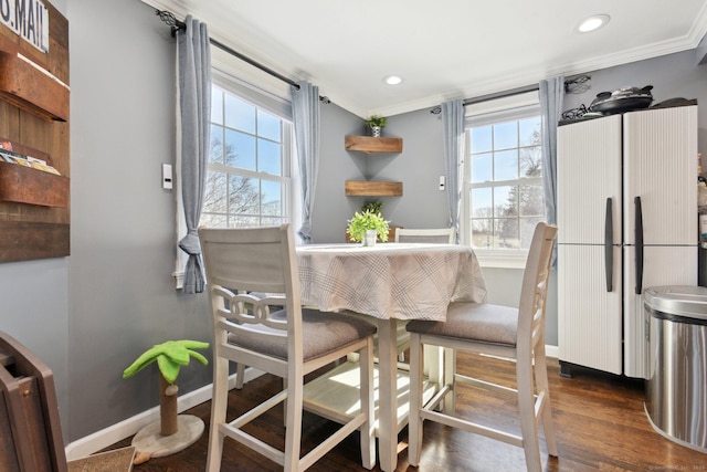 dining space featuring dark hardwood / wood-style flooring and ornamental molding