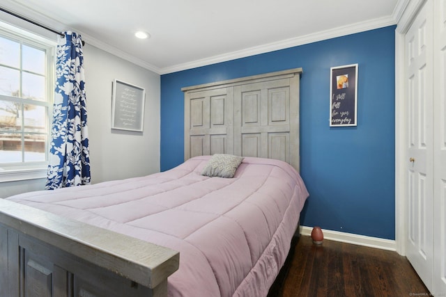 bedroom featuring ornamental molding, dark hardwood / wood-style flooring, and a closet