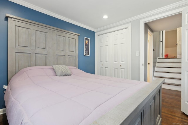 bedroom with ornamental molding, dark hardwood / wood-style floors, and a closet