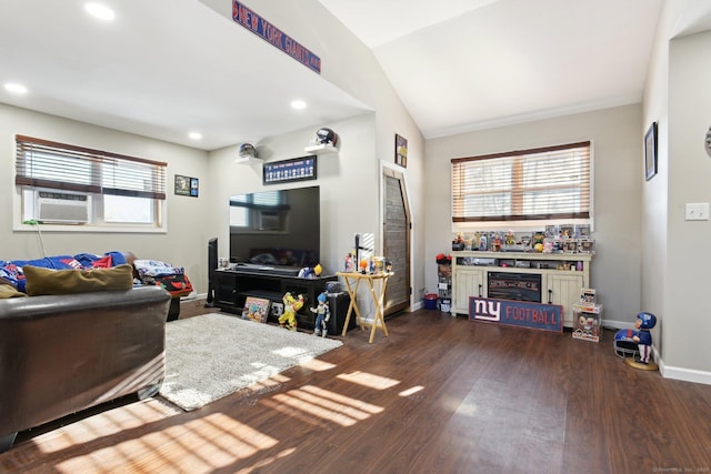 living room featuring cooling unit, dark wood-type flooring, and vaulted ceiling