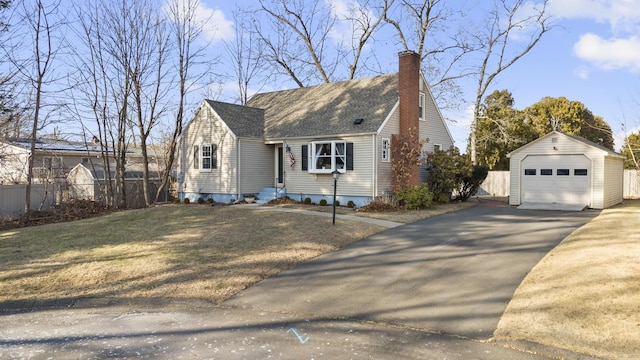 view of front of house with an outdoor structure, a garage, and a front lawn