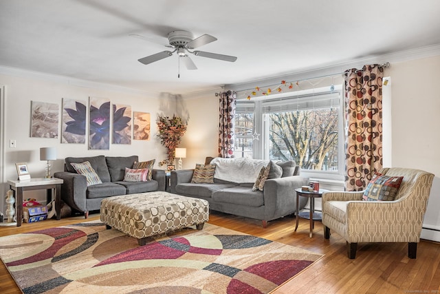 living room featuring ceiling fan, crown molding, a baseboard radiator, and light hardwood / wood-style flooring