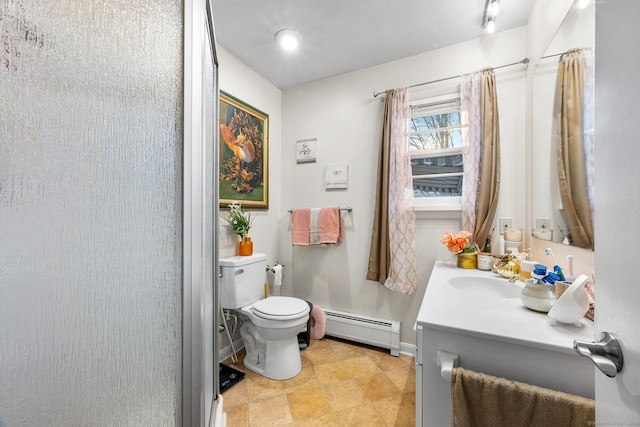 bathroom featuring toilet, vanity, and a baseboard radiator