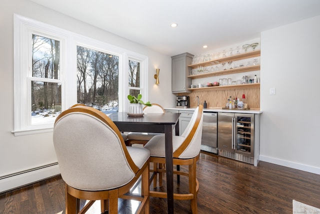 dining room featuring beverage cooler, dark wood-type flooring, and plenty of natural light