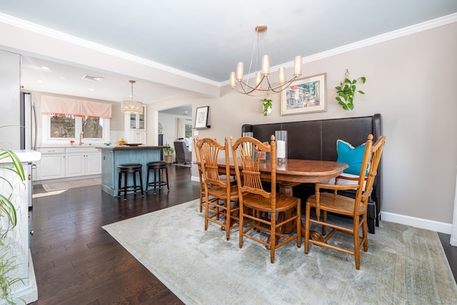 dining space with baseboards, dark wood finished floors, visible vents, and crown molding