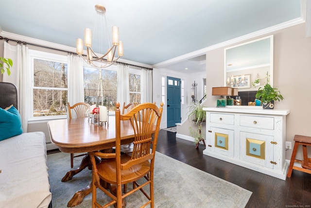 dining area featuring dark wood-style floors, a baseboard radiator, crown molding, and an inviting chandelier