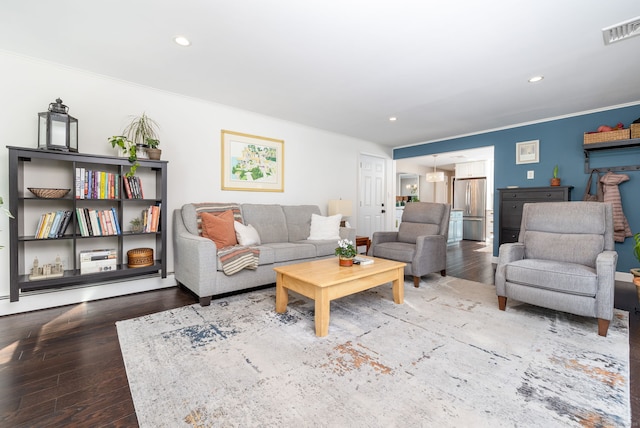 living area with visible vents, ornamental molding, wood finished floors, and recessed lighting