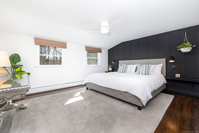 bedroom featuring dark wood-style floors, ceiling fan, a baseboard radiator, and lofted ceiling