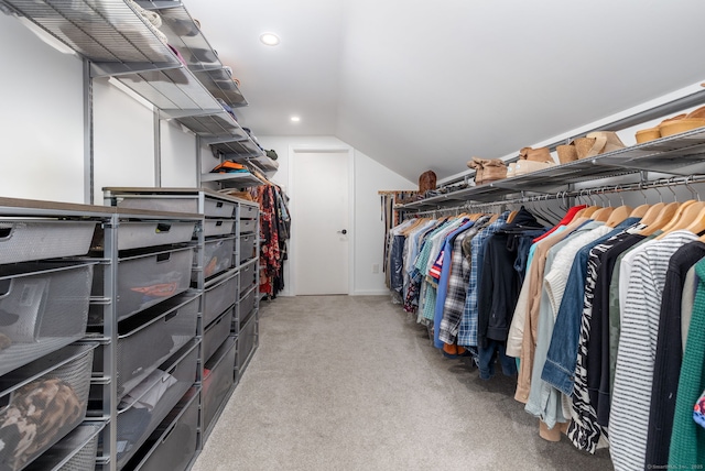 spacious closet with lofted ceiling and carpet flooring