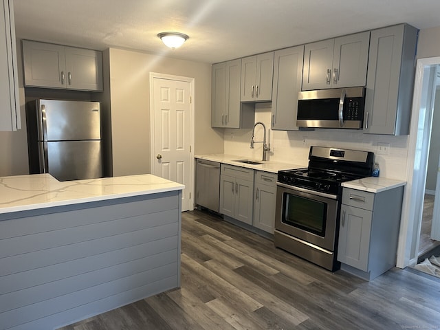 kitchen with sink, appliances with stainless steel finishes, and gray cabinetry