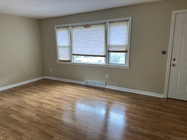 spare room with wood-type flooring