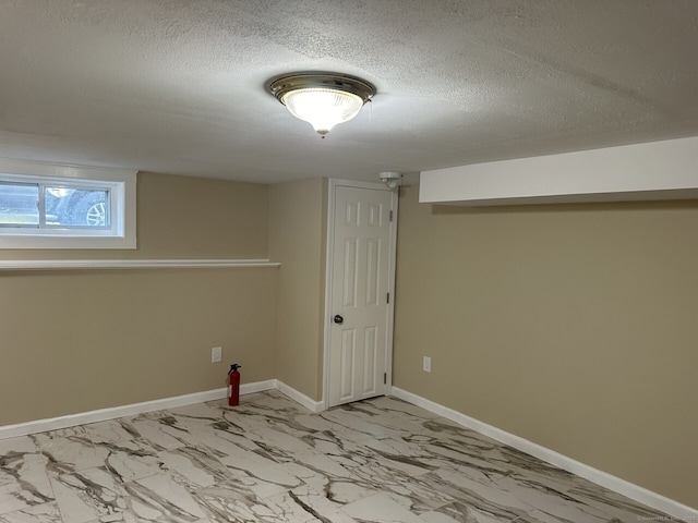 basement featuring a textured ceiling