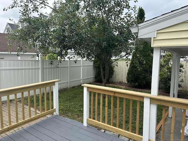 wooden terrace featuring a yard