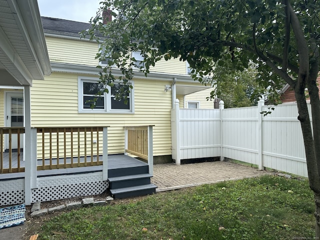 wooden terrace with a patio area